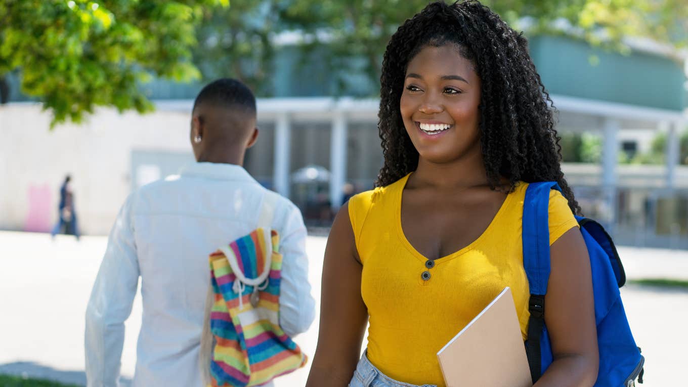 College student smiling while walking around campus