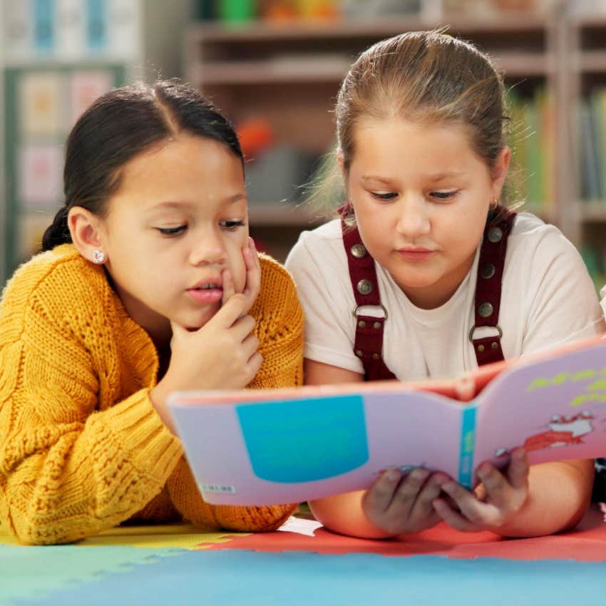 Young students with accommodations reading together.