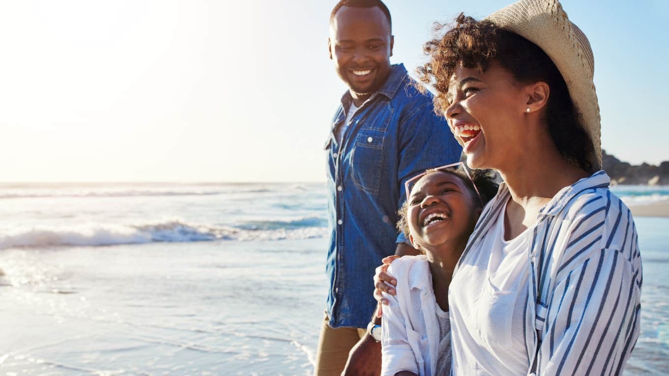 family walking together on vacation by the beach