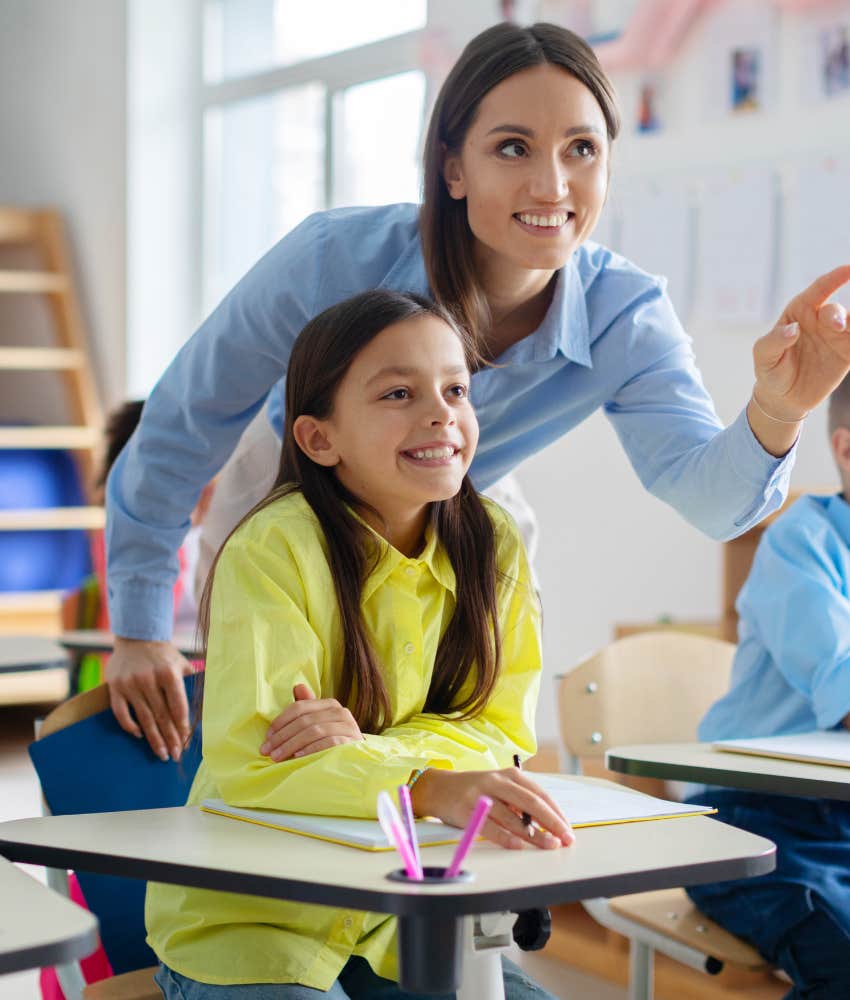 Substitute teacher helping student in class