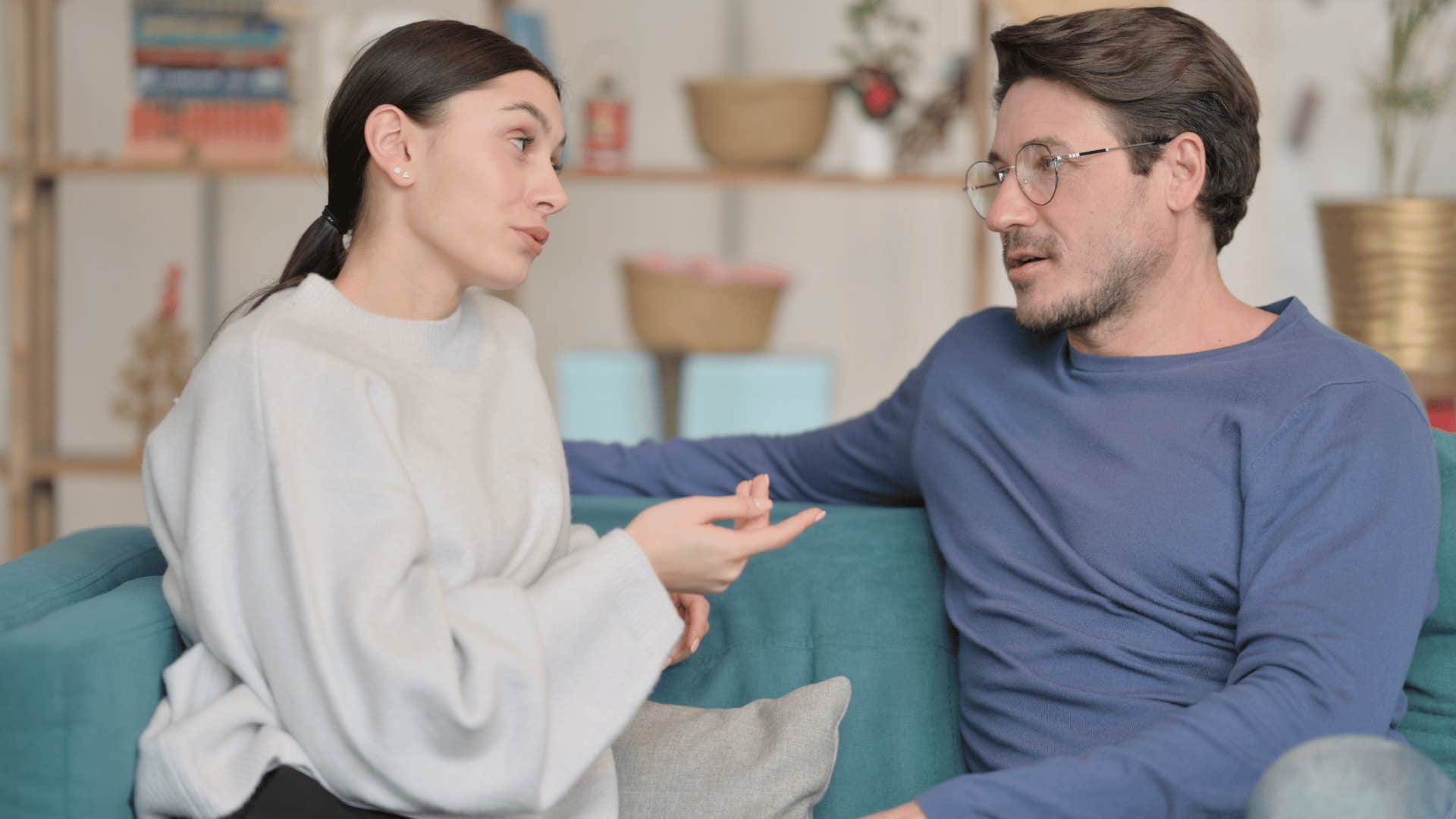 woman talking to man on couch