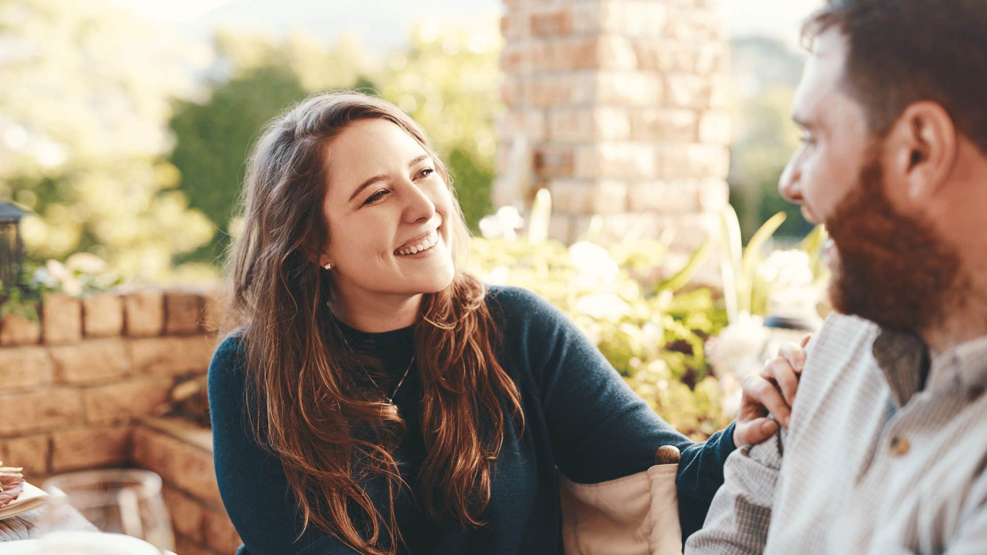 woman listening to man while smiling 