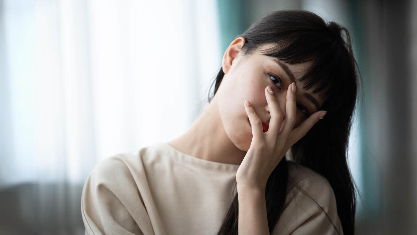 Woman with her hand on her face, negative home life