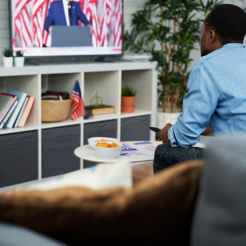 man watching political rally on television 