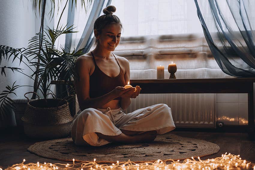 Young woman sitting on the floor to do yoga exercise at home. 