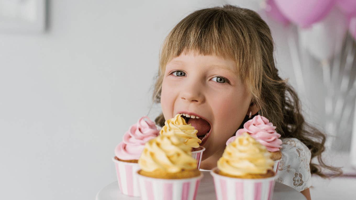 little girl with cupcakes