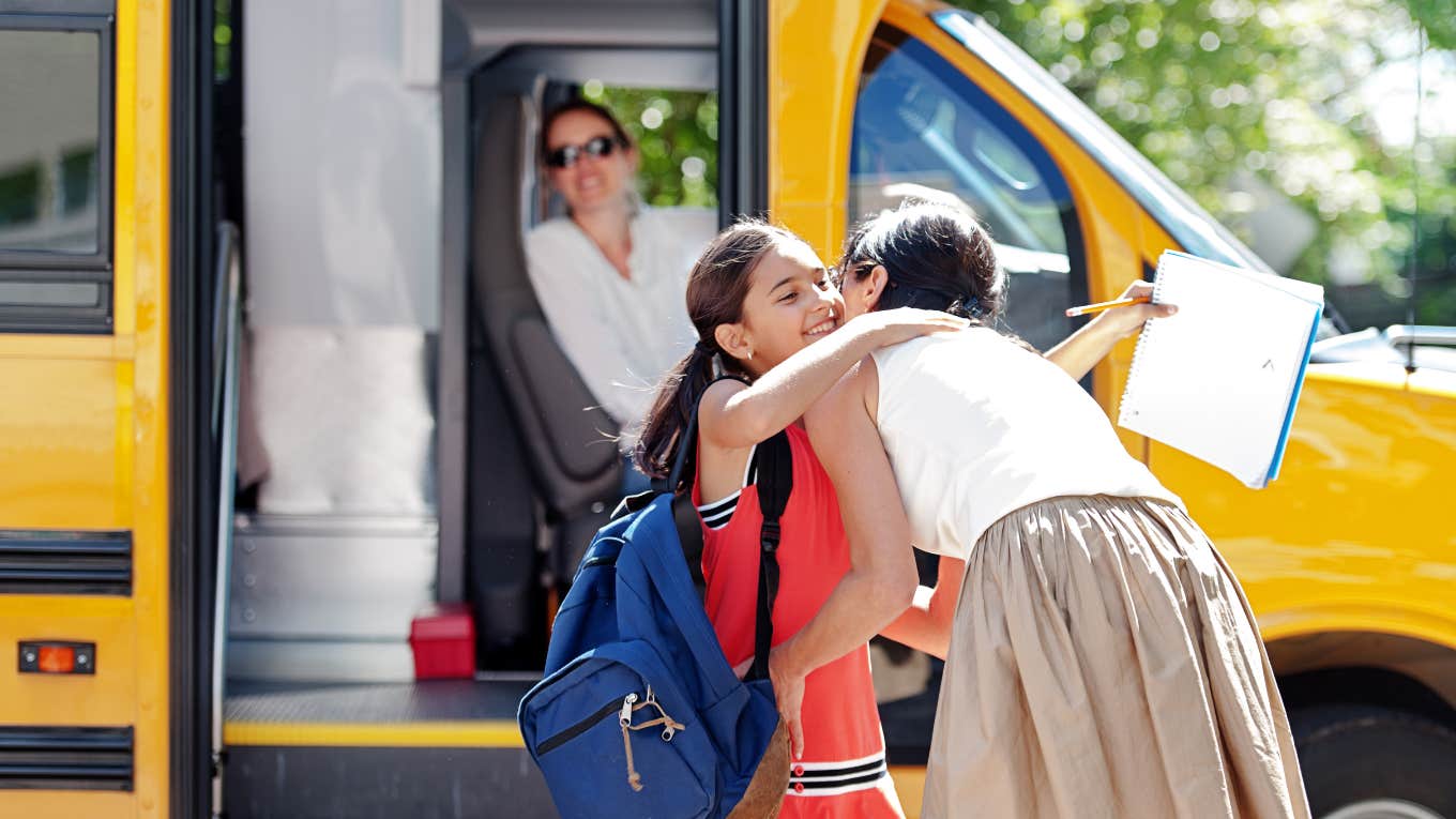 kid getting on the school bus