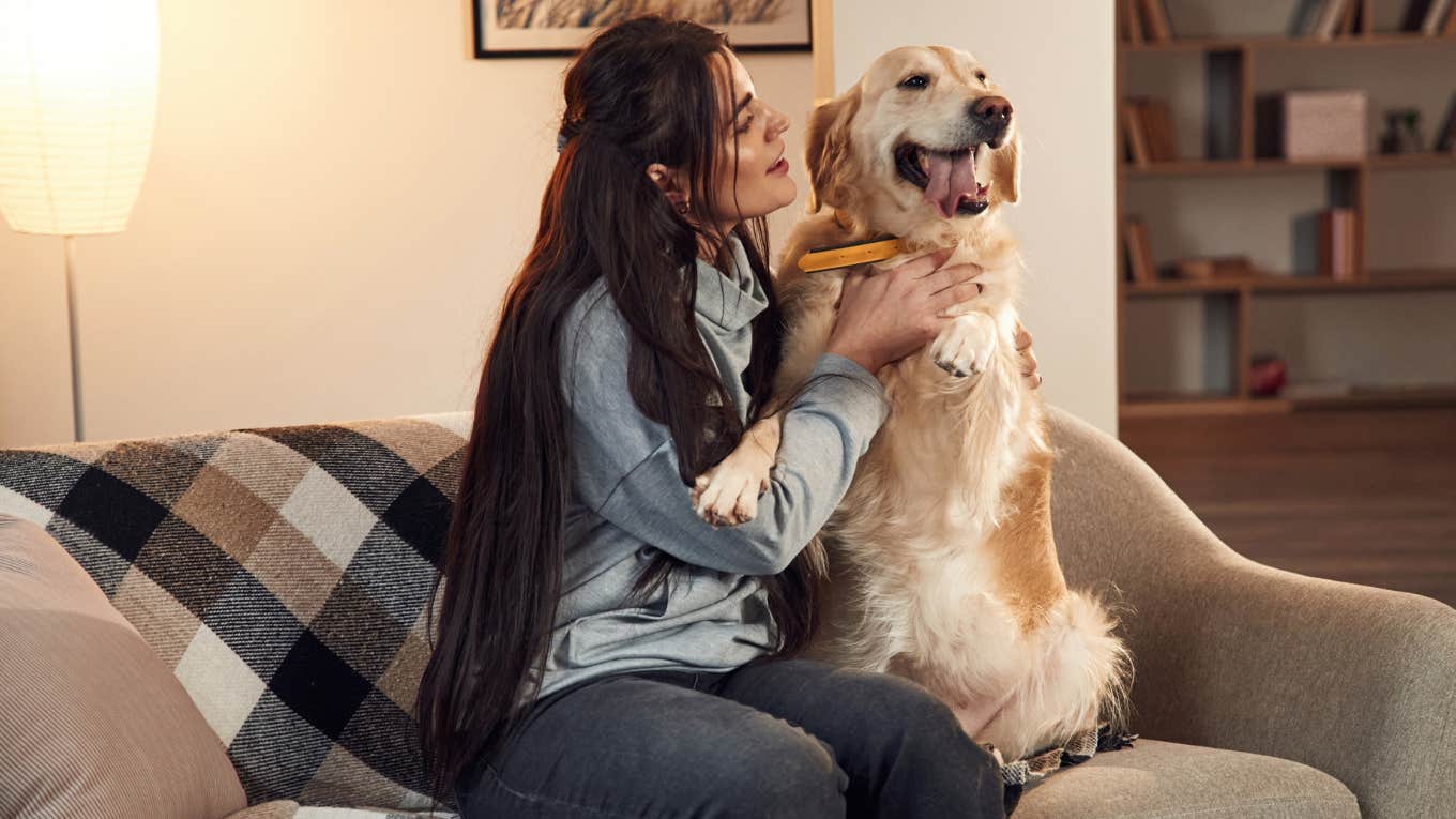 Dog owner sitting with their pet. 