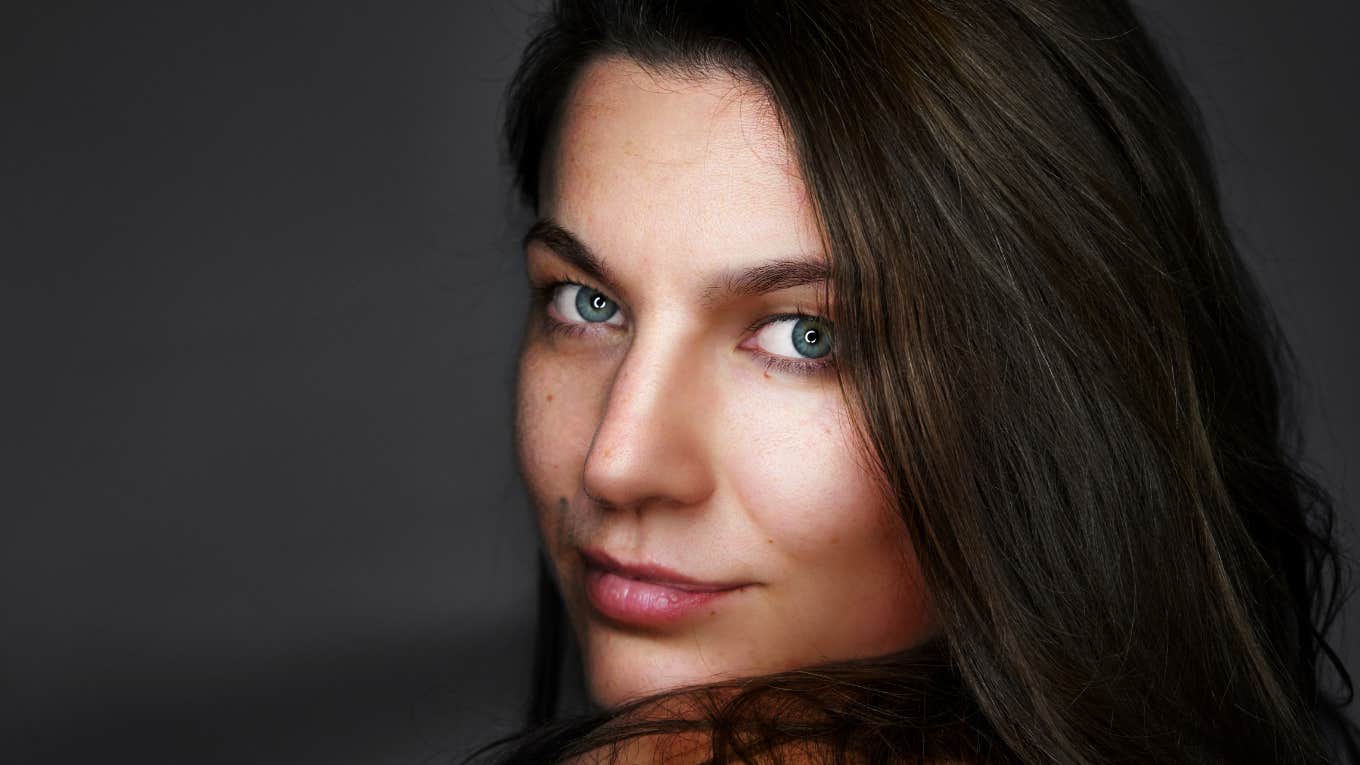 Beautiful brunette woman staring intently with a slight smile