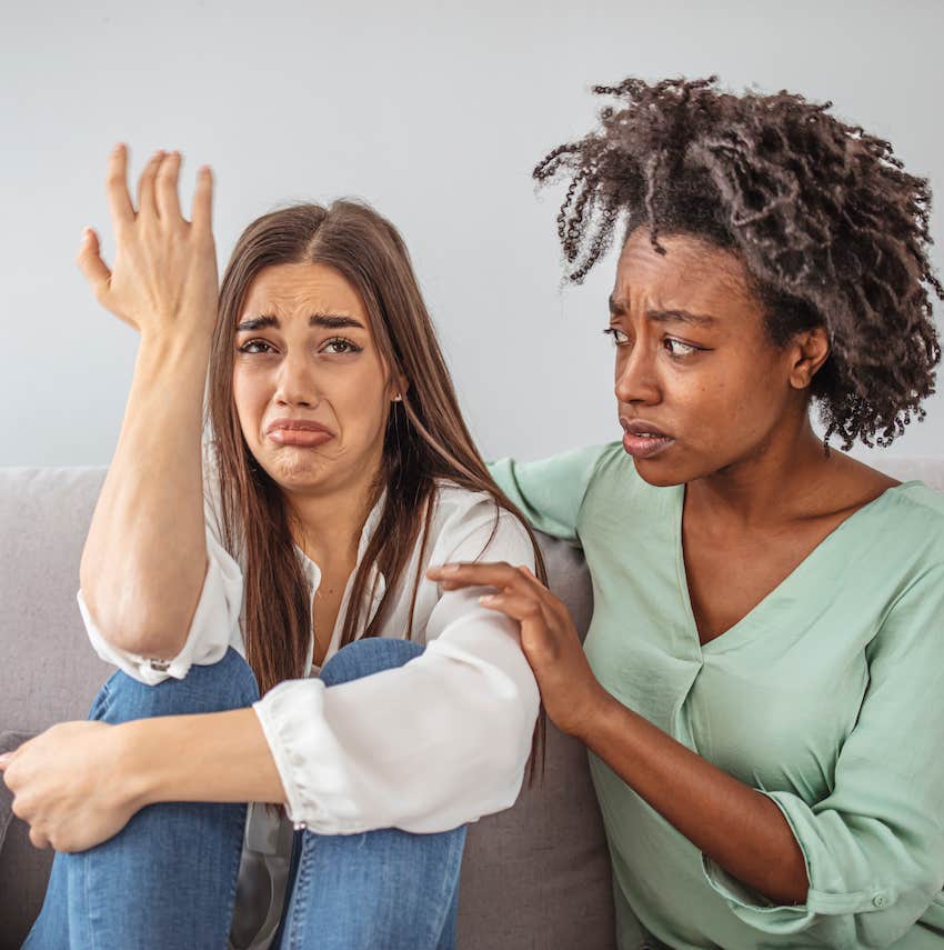 Upset woman is being comforted by another woman