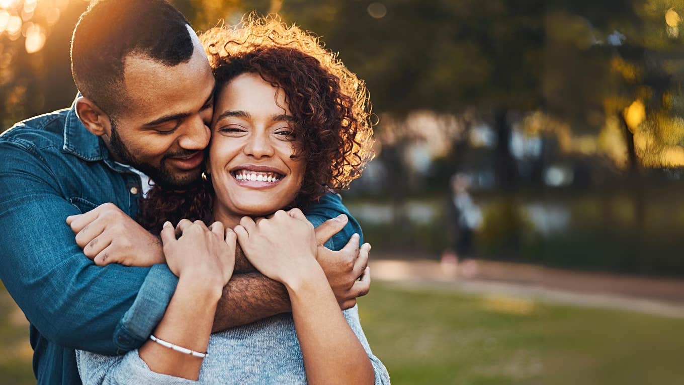 Sociopathic man hugging woman from behind