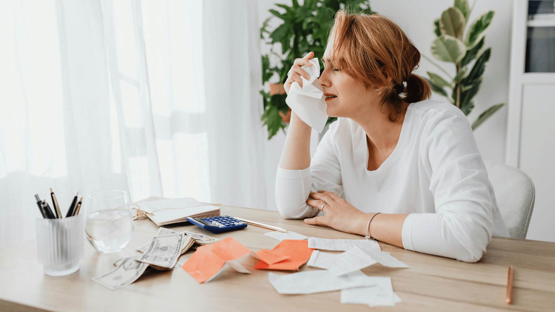 woman crying over paying bills money