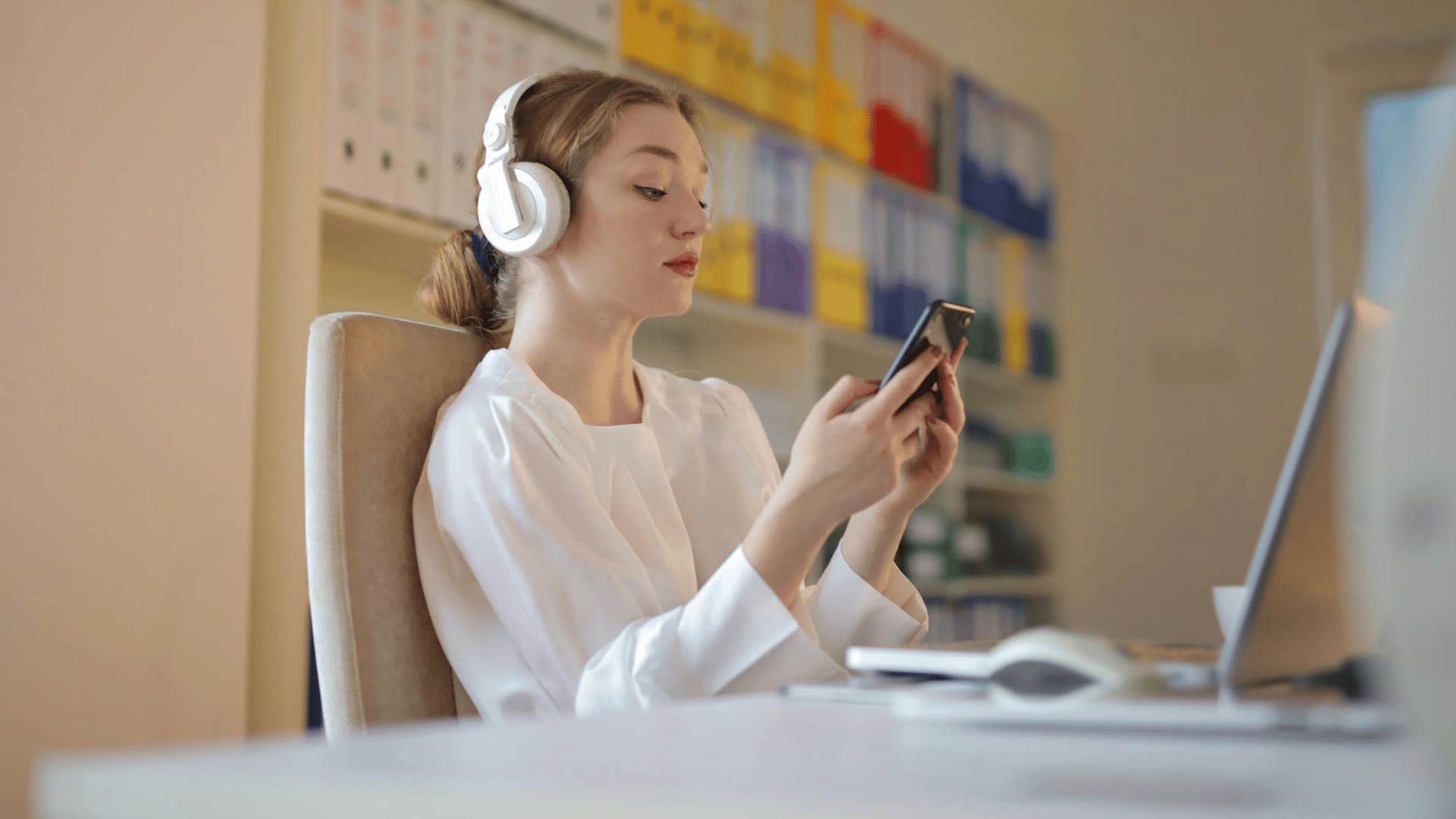 woman on her phone and computer