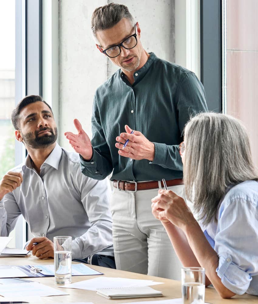 three employees in a meeting