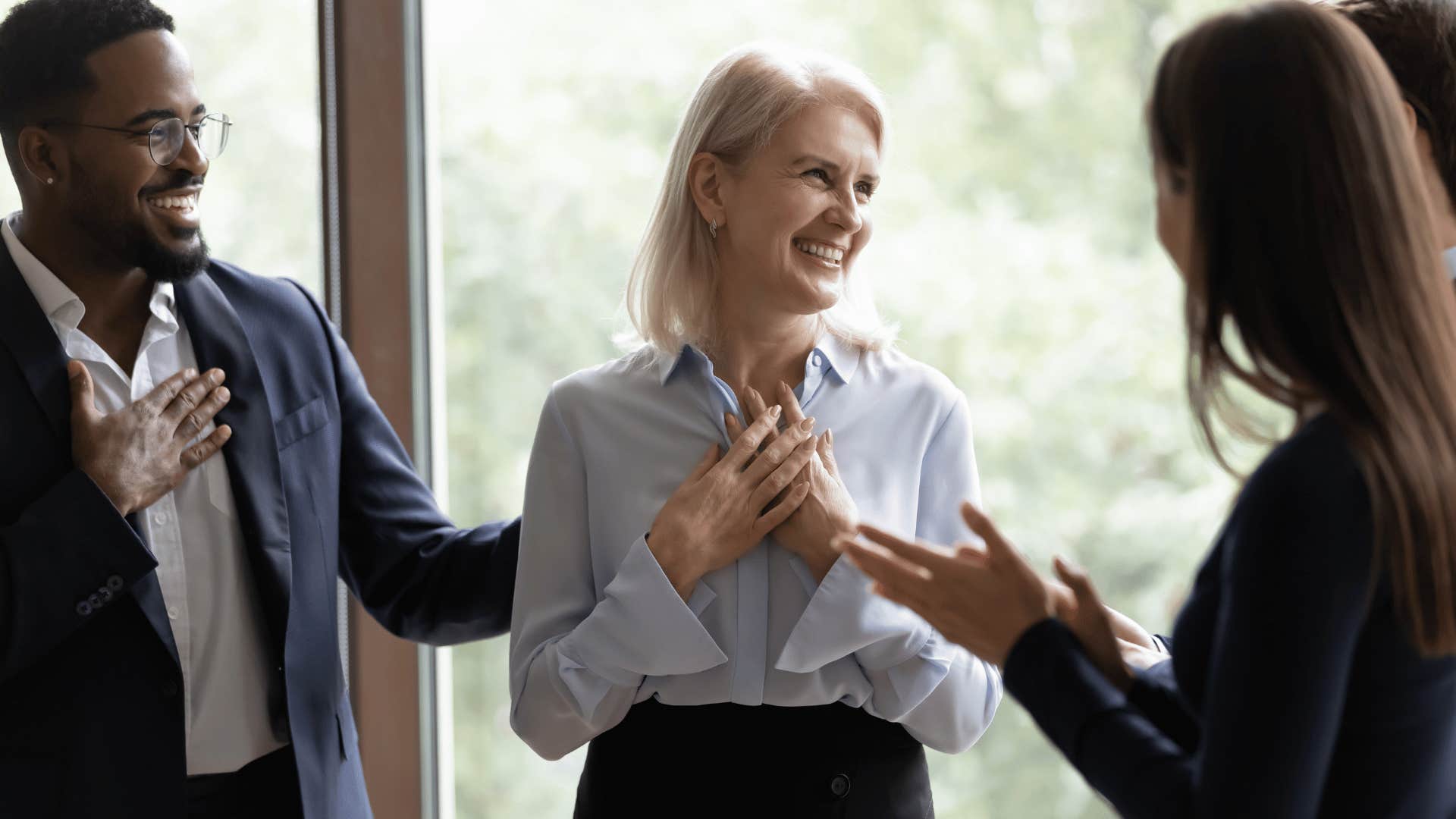 woman being congratulated by peers