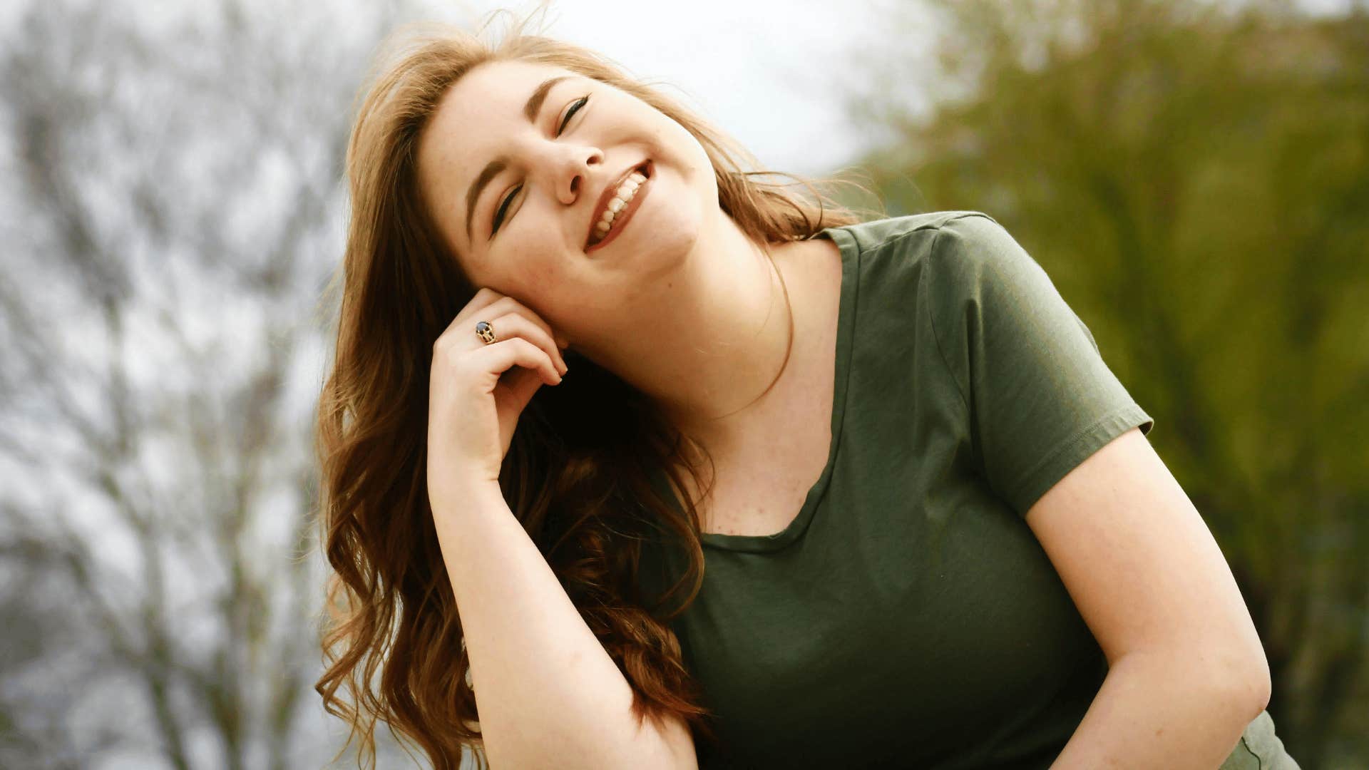 woman smiling with eyes closed