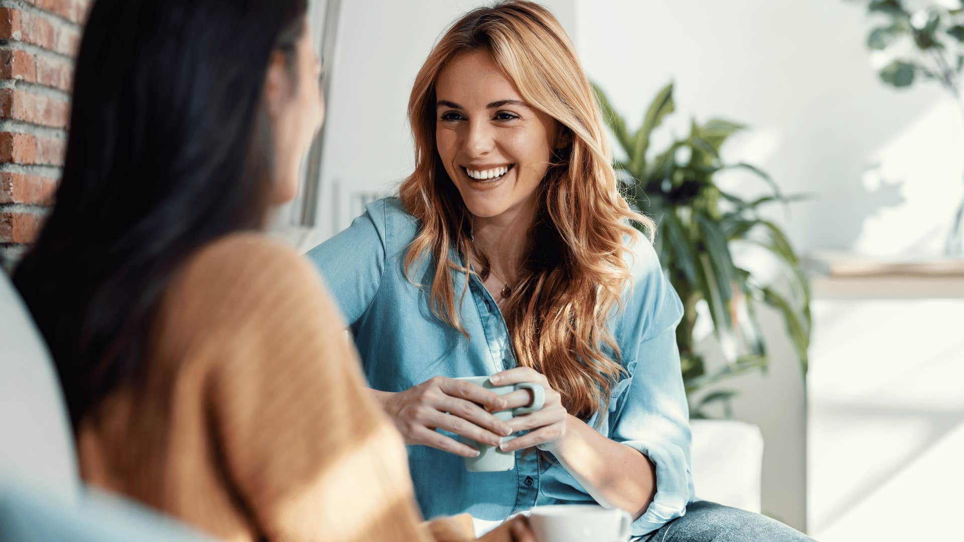 woman listening and smiling at other woman