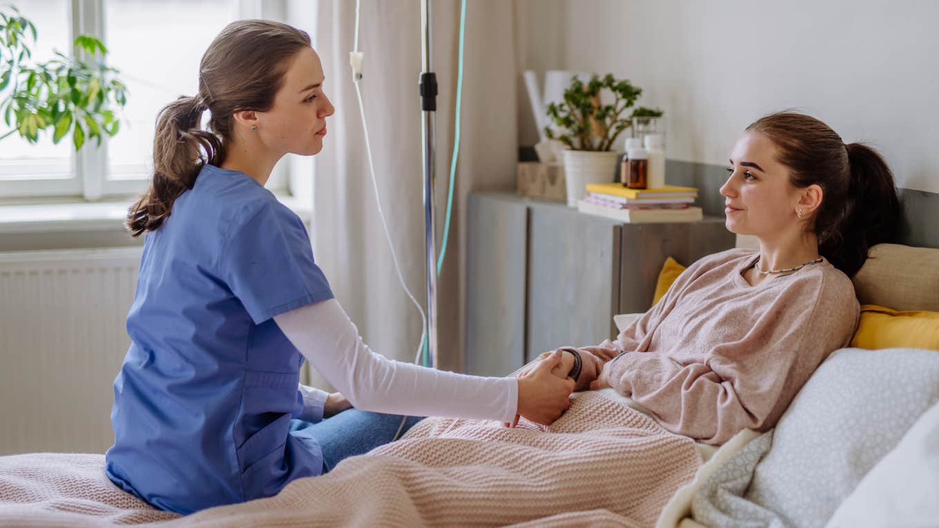 Young nurse taking care of teenage girl.