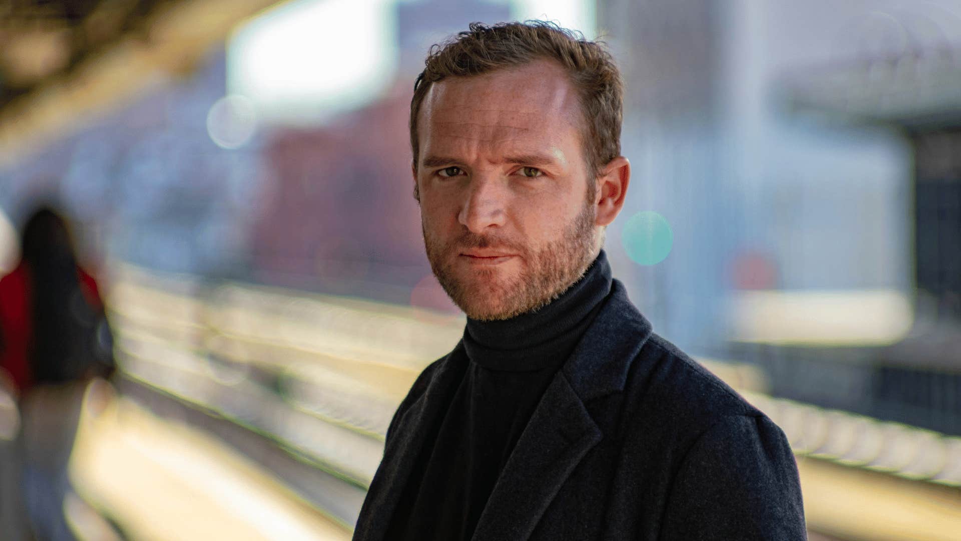 man standing on train platform