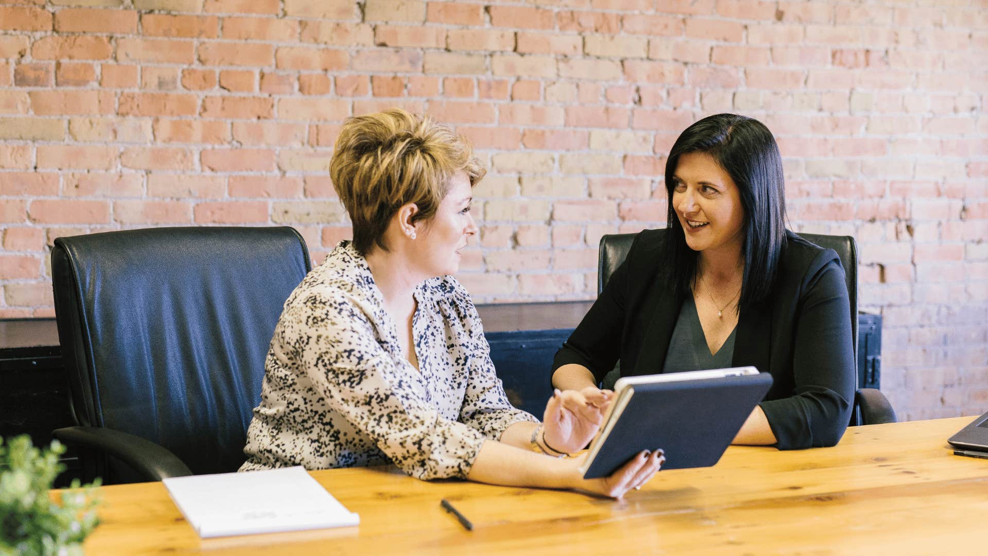 two professional women talking and asking questions