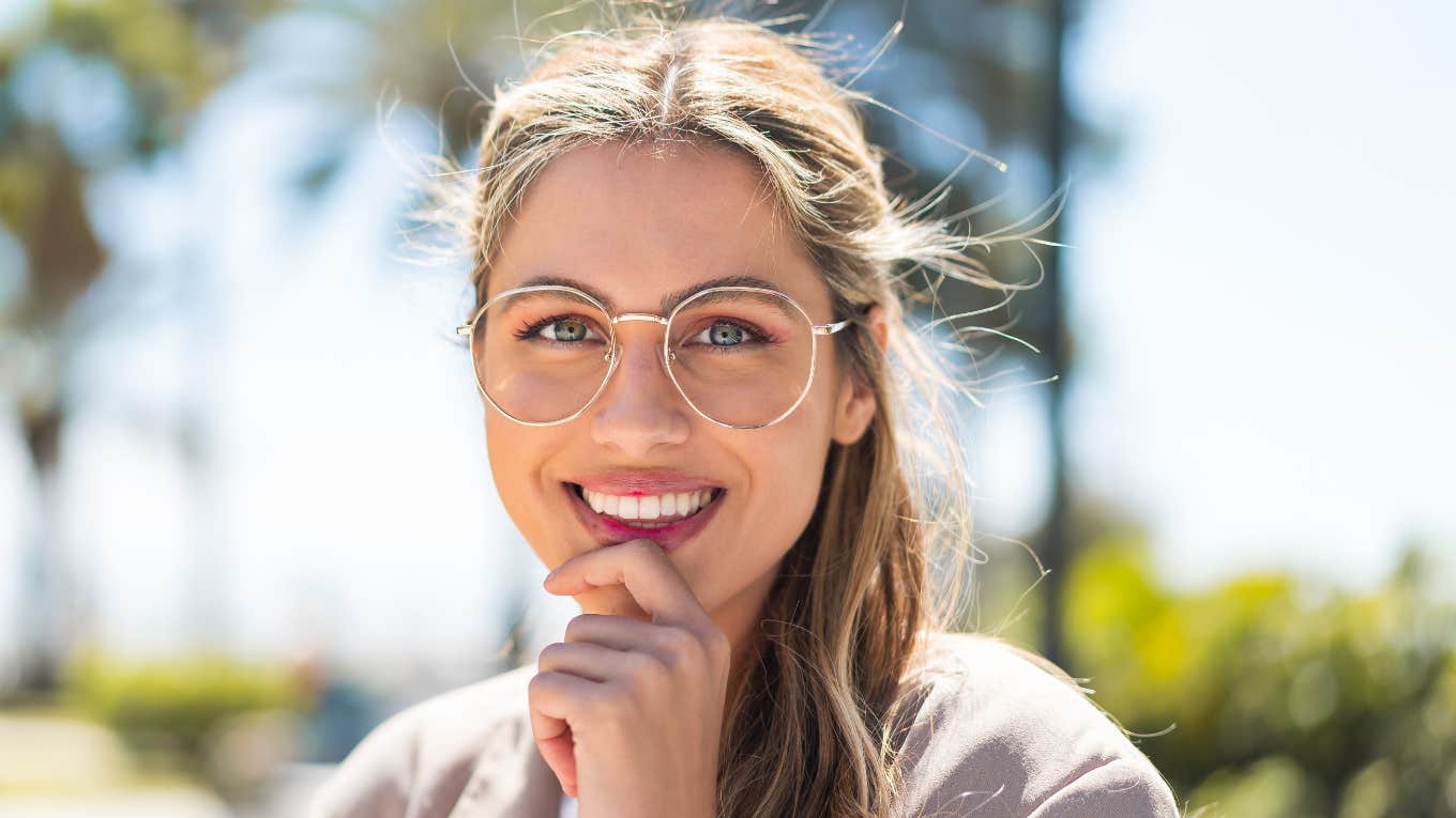 woman with glasses smiling