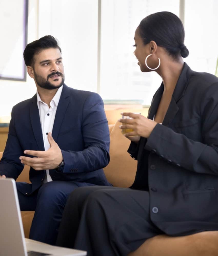 two co-workers talking