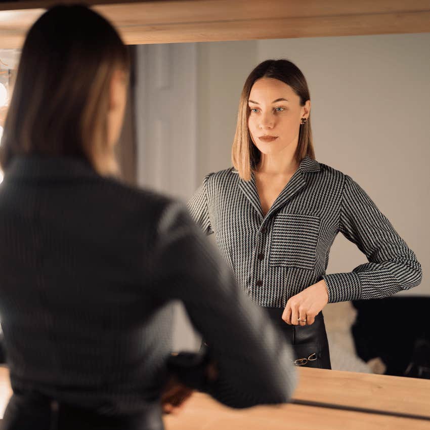 woman looking in mirror