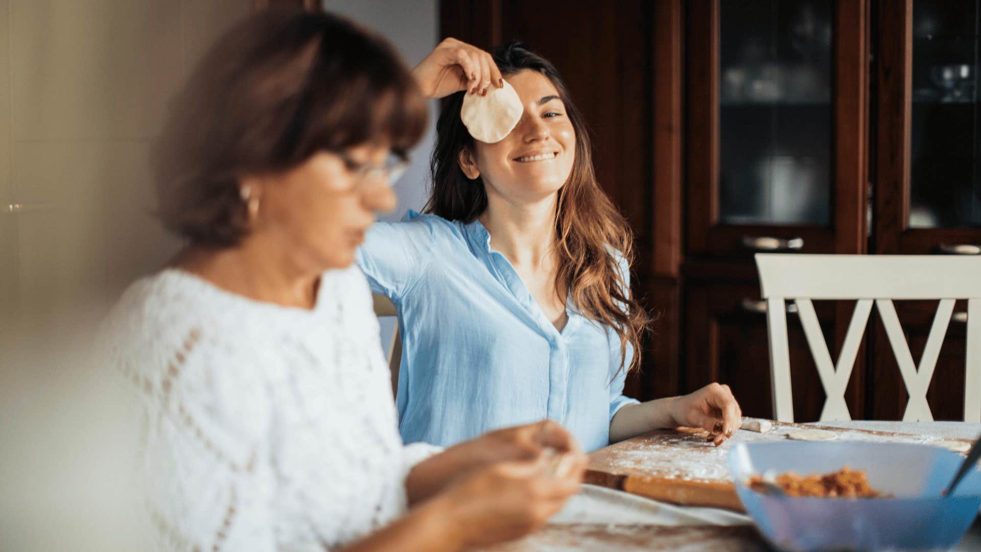 woman holding up food to eye