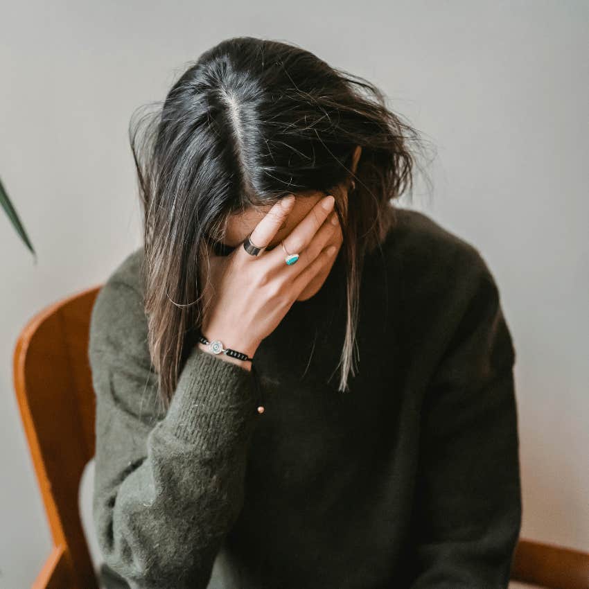 upset woman covering face with hand