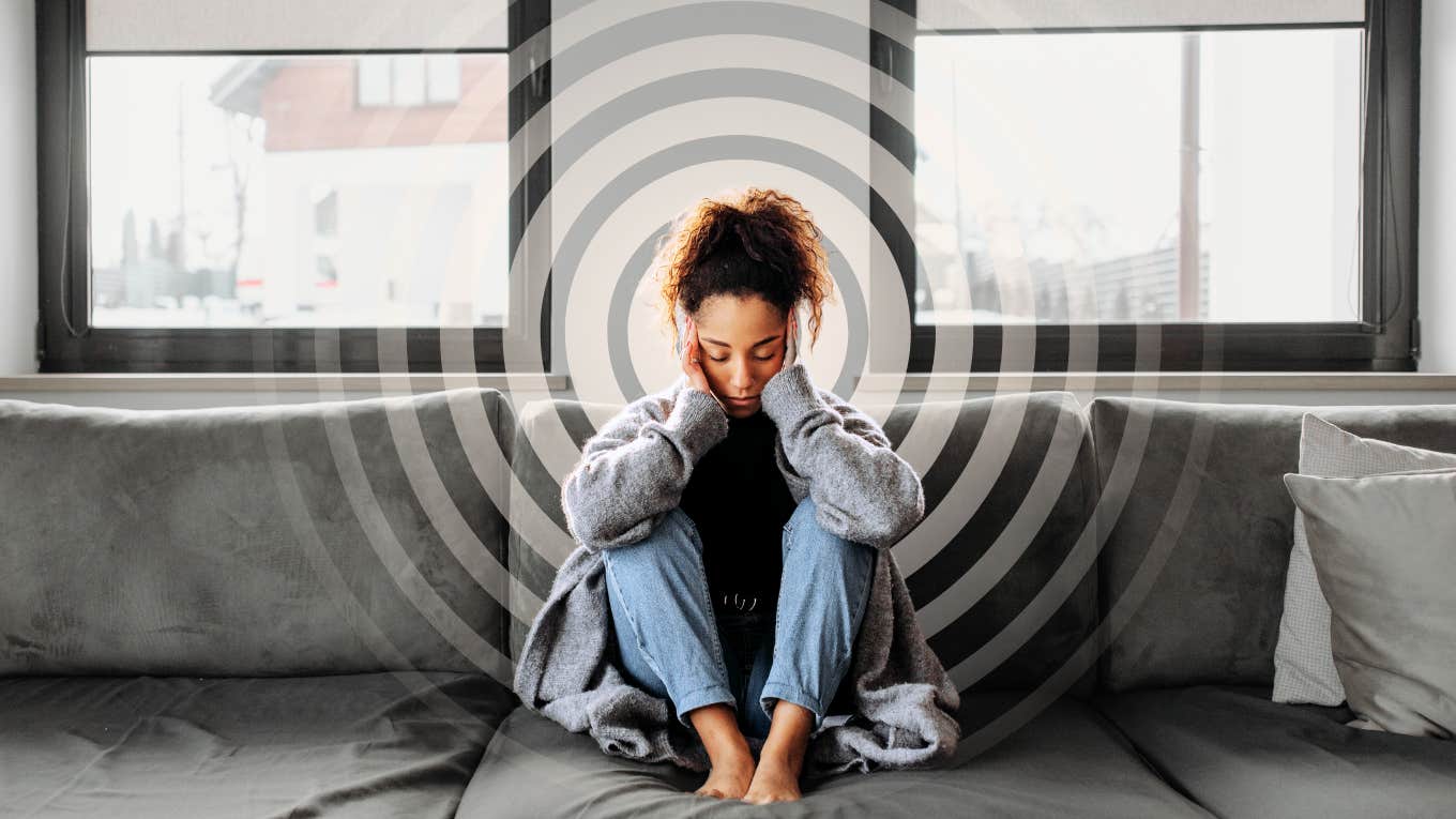 Woman fatigued with a headache, stuck in low vibrational pattern