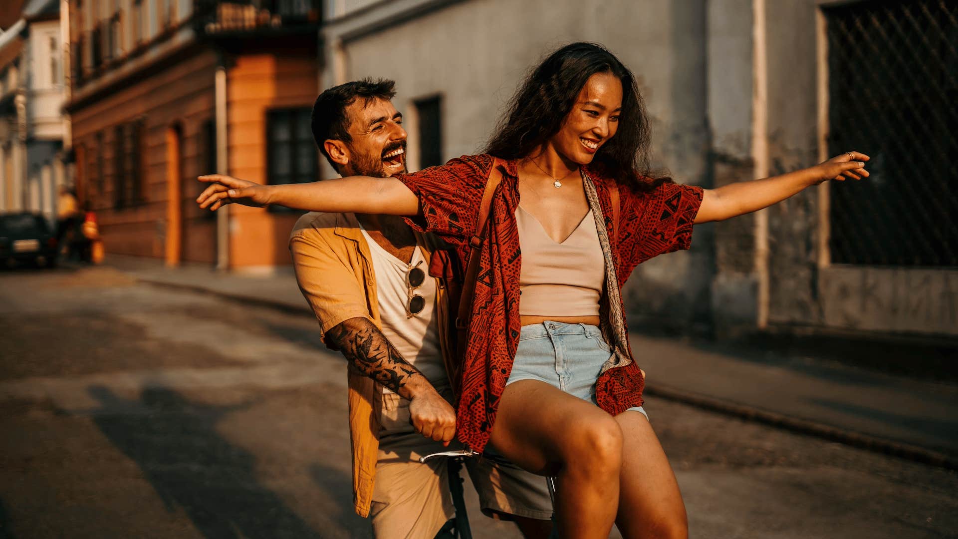 Adventurous couple riding bicycle