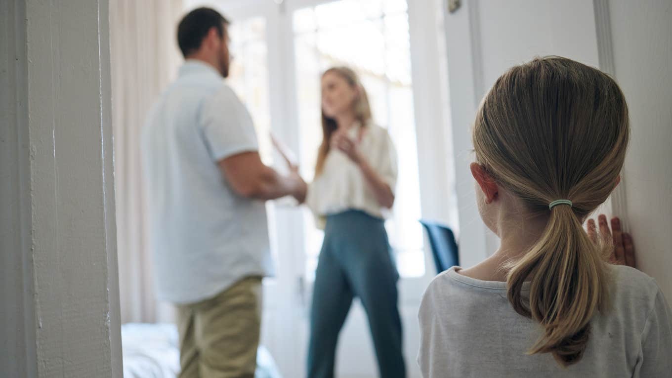 Shot of a little girl watching her parents argue at home.