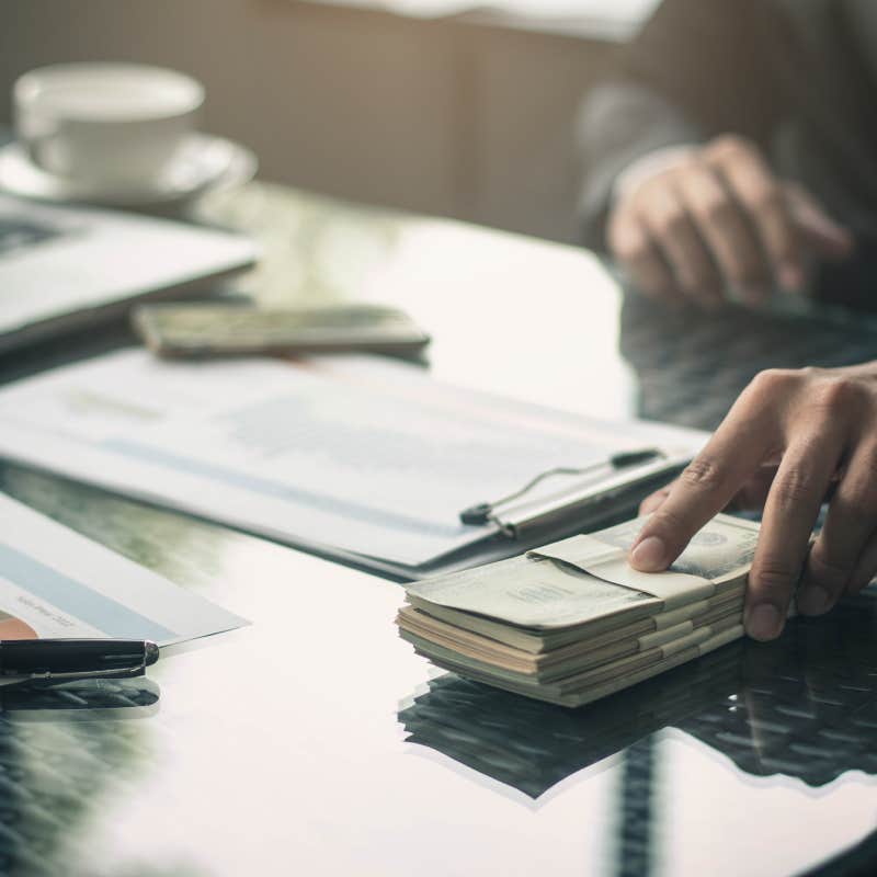 close up of man counting money