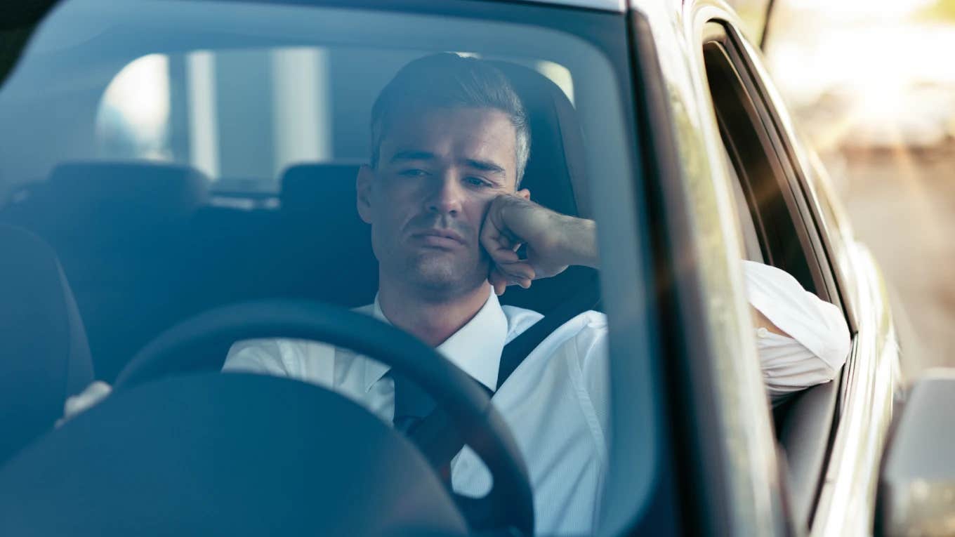 husband sitting in car during a family emergency