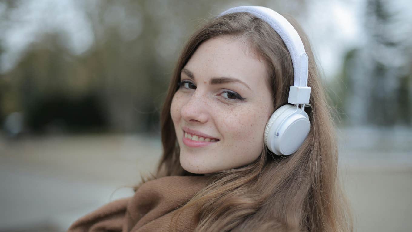 Smiling woman alone with headphones