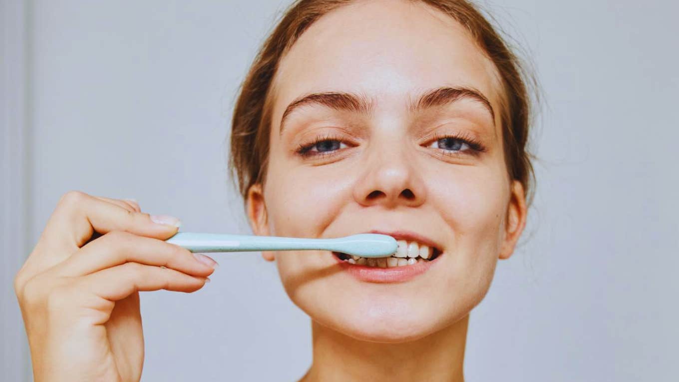 woman brushing teeth 