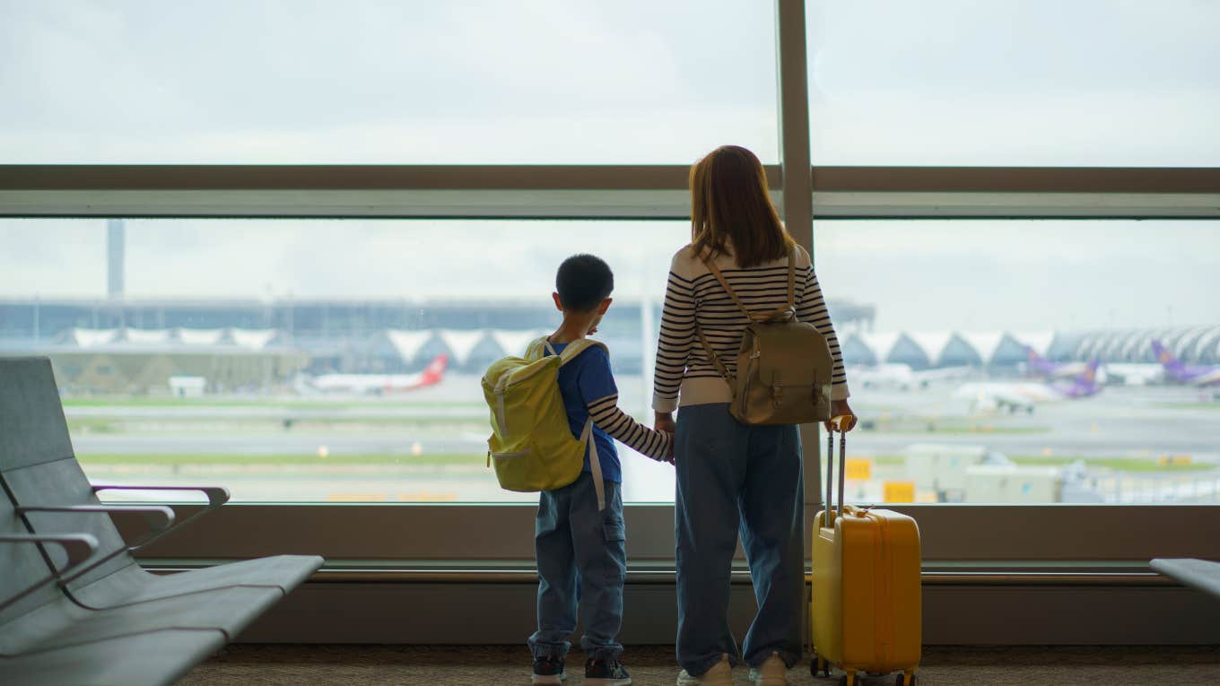 Mother and son watching their plane depart after being kicked off flight