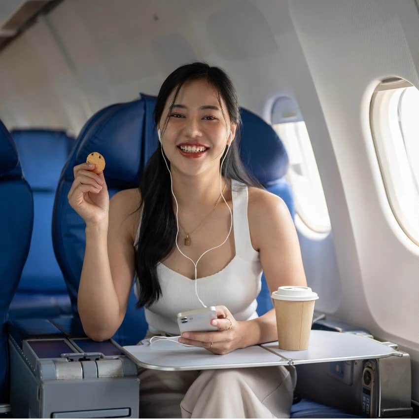 Woman eating on an airplane