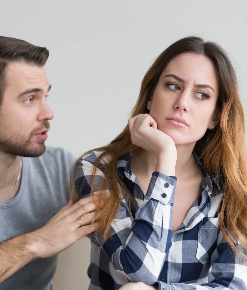 Woman feeling emotionally distant as man tries to talk to her