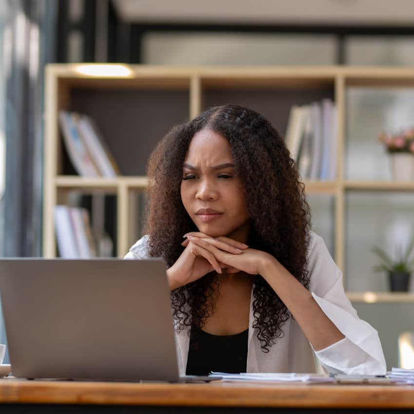 Woman looking stressed filling out a job application. 