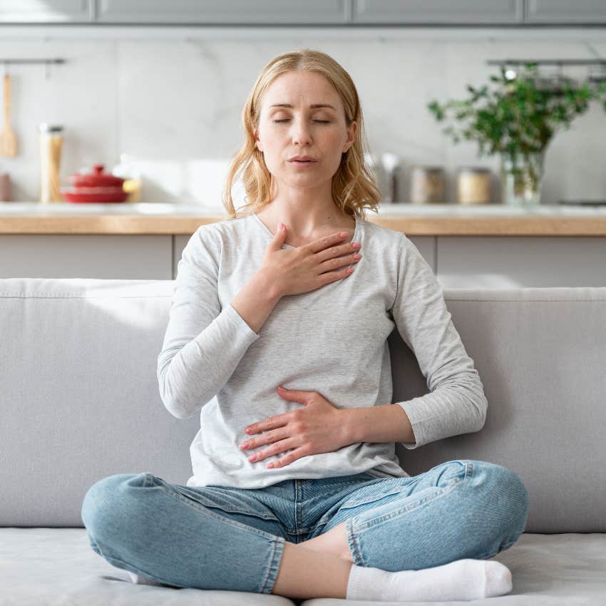 Woman listening to her body's signals which are messages from her intuition