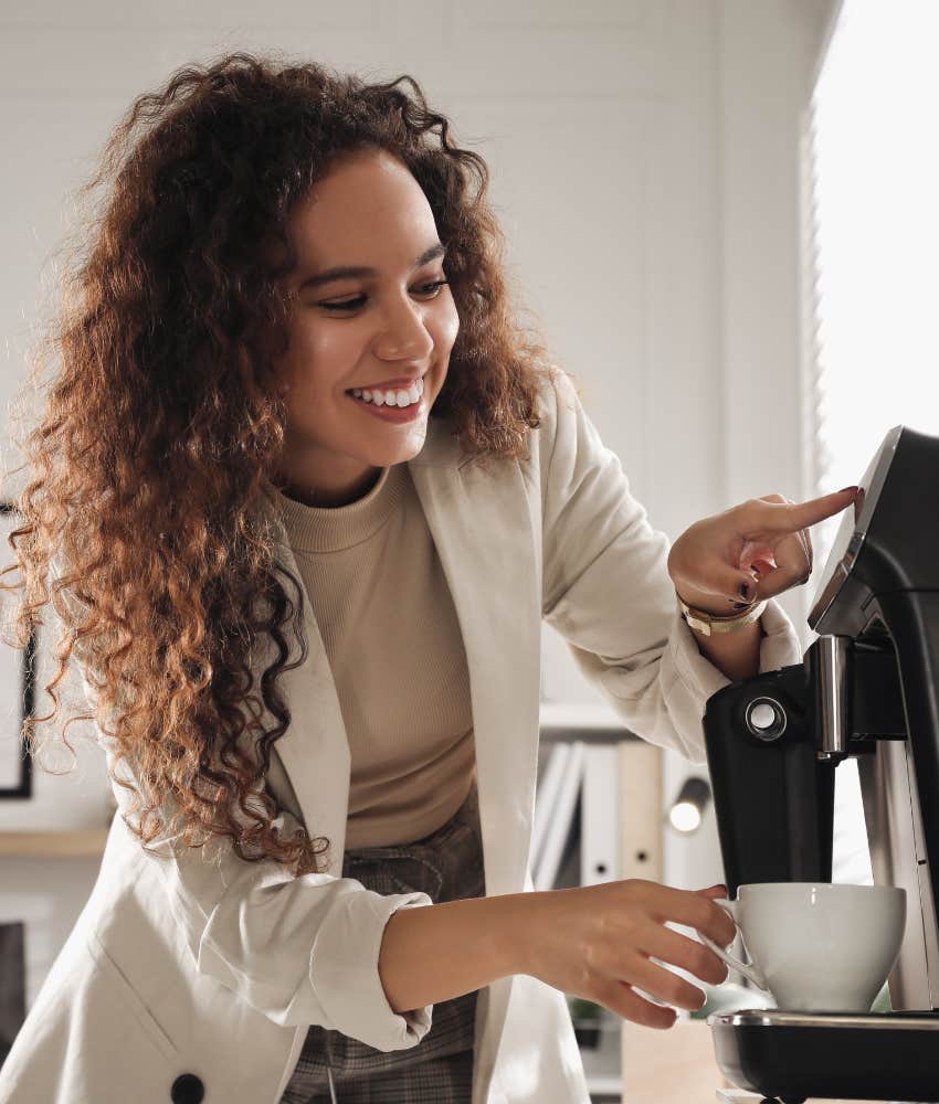 Woman making a cup of coffee at work