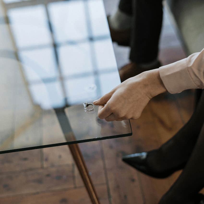 woman initiating divorce placing ring on table