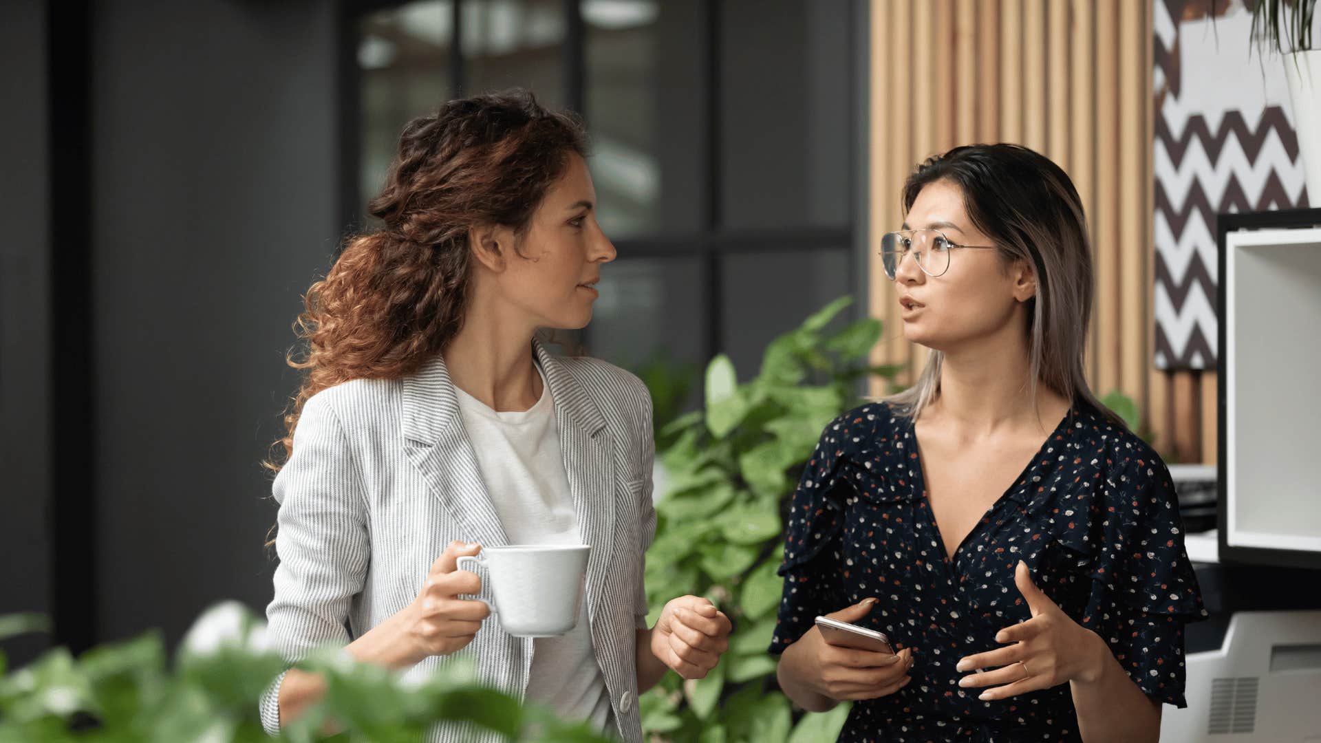 women in an office talking