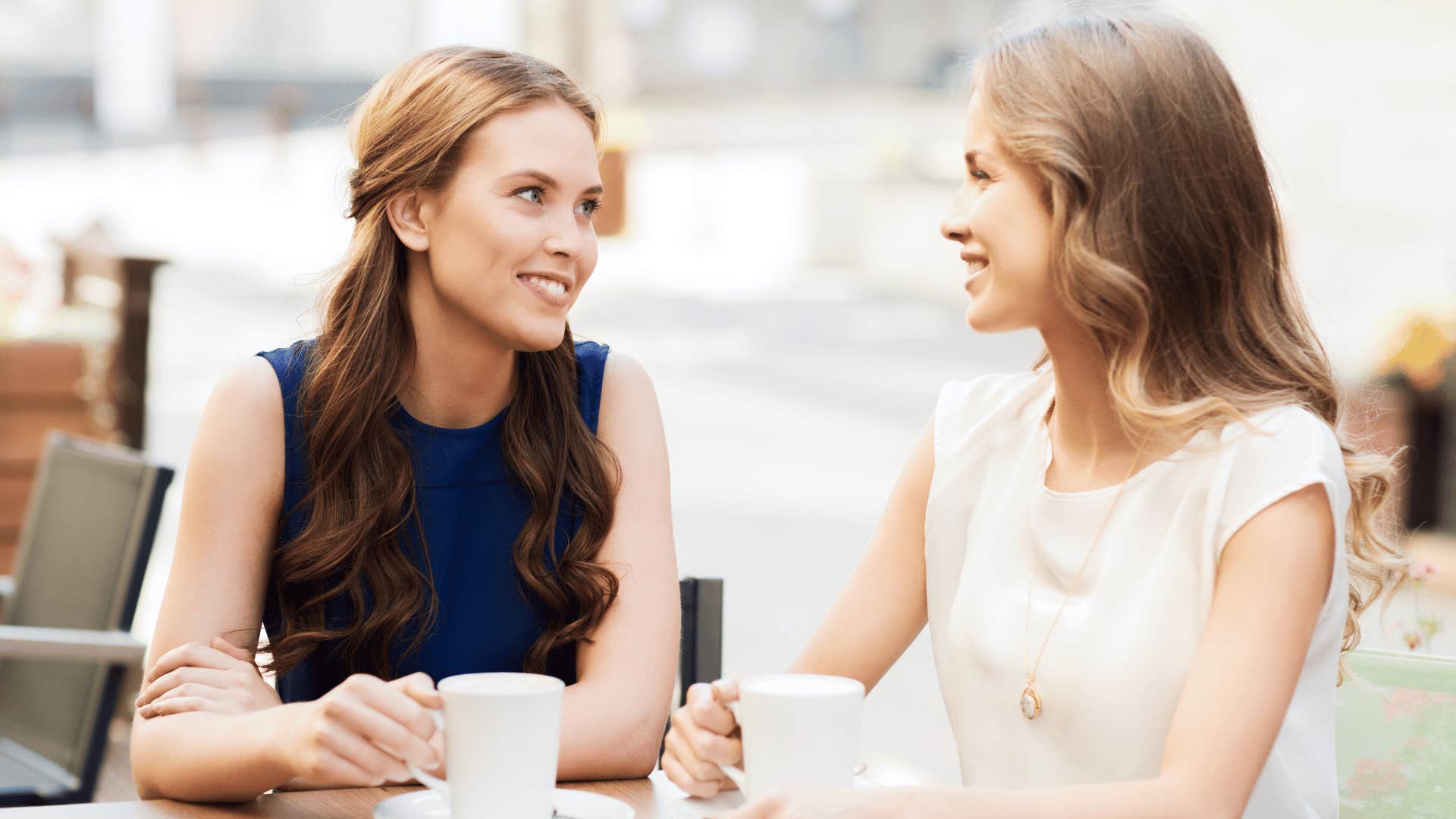 two women drinking coffee