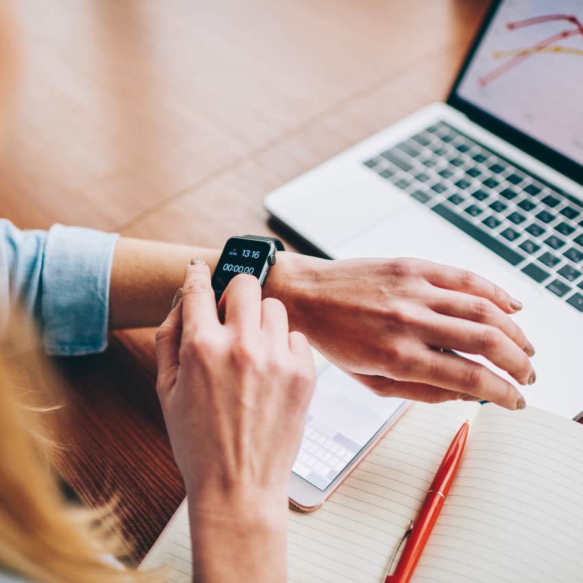 Woman setting 5 minute timer to get work done