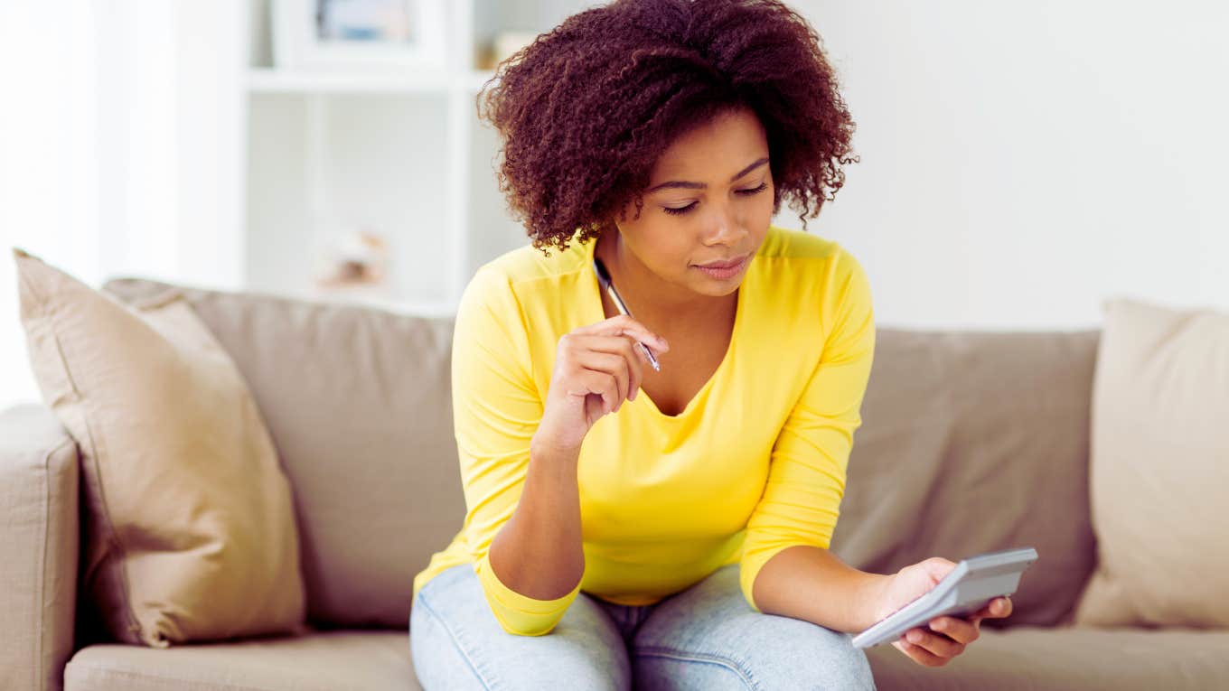 woman looking through bills