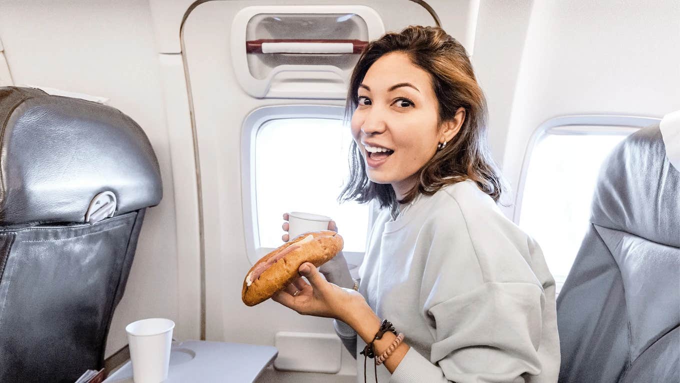 Woman eating on on airplane