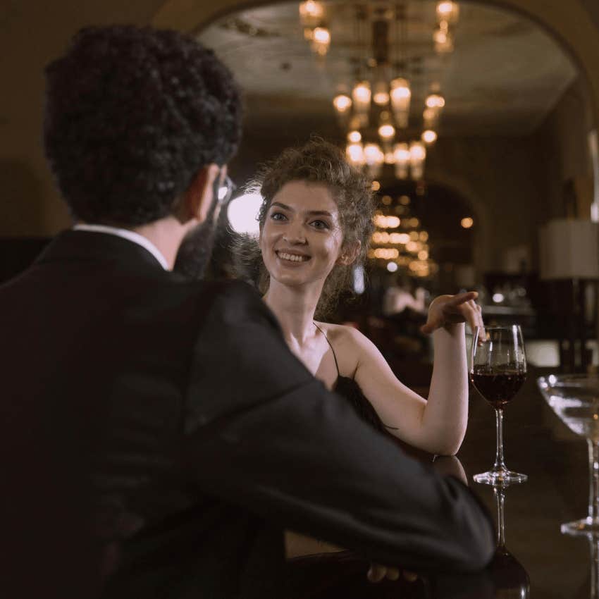 woman smiling eyes surprised talking woman bar