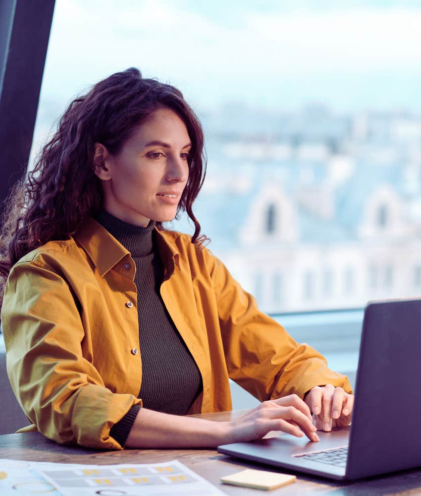 Woman typing on her laptop in an office